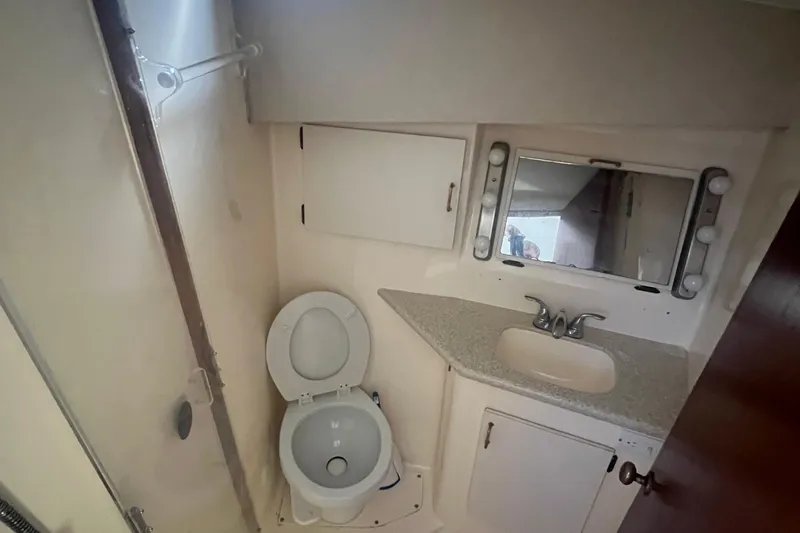 Slide: The Image of Bathroom interior of 1990 Ocean Yachts 35 Sport Sedan with toilet, sink, and mirror. - 18