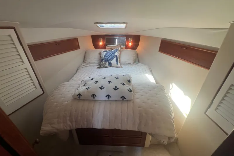 Slide: The Image of Cozy bedroom in 1990 Ocean Yachts 35 Sport Sedan with nautical-themed bedding. - 19