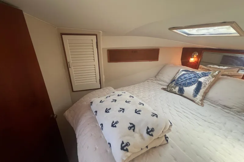 Slide: The Image of Cozy bedroom in 1990 Ocean Yachts 35 Sport Sedan with nautical-themed decor. - 20