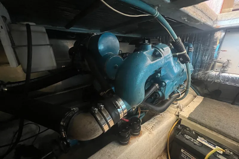 Slide: The Image of Engine compartment of a 1990 Ocean Yachts 35 Sport Sedan, showcasing marine engine components. - 23