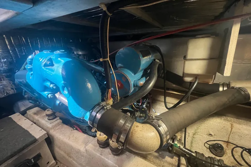 Slide: The Image of Engine compartment of a 1990 Ocean Yachts 35 Sport Sedan, featuring blue engine components. - 24