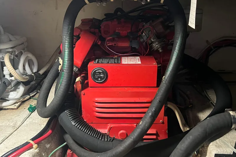 Slide: The Image of Engine compartment of a 1990 Ocean Yachts 35 Sport Sedan with red machinery and hoses. - 25