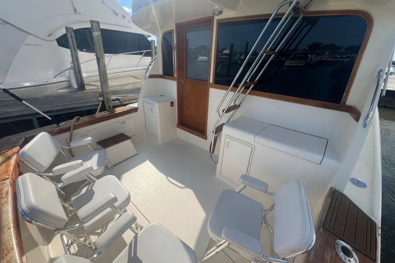 Slide: The Image of 1990 Ocean Yachts 35 Sport Sedan boat deck with seating and storage. - 4