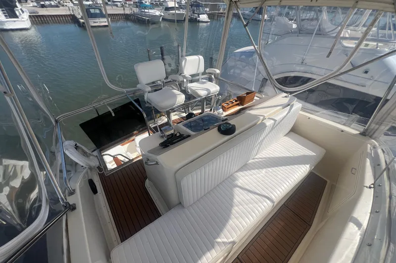 Slide: The Image of 1990 Ocean Yachts 35 Sport Sedan interior with seating and helm, docked at marina. - 6