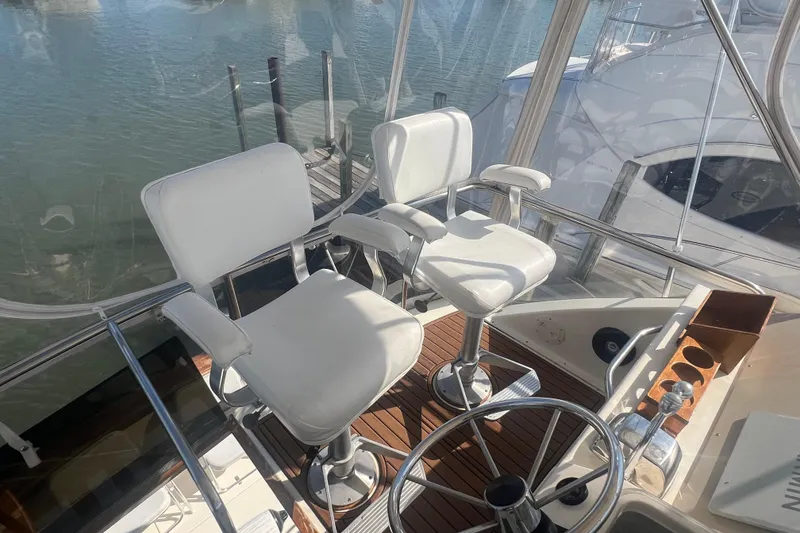 Slide: The Image of Cockpit of 1990 Ocean Yachts 35 Sport Sedan with white captain chairs and steering wheel. - 7