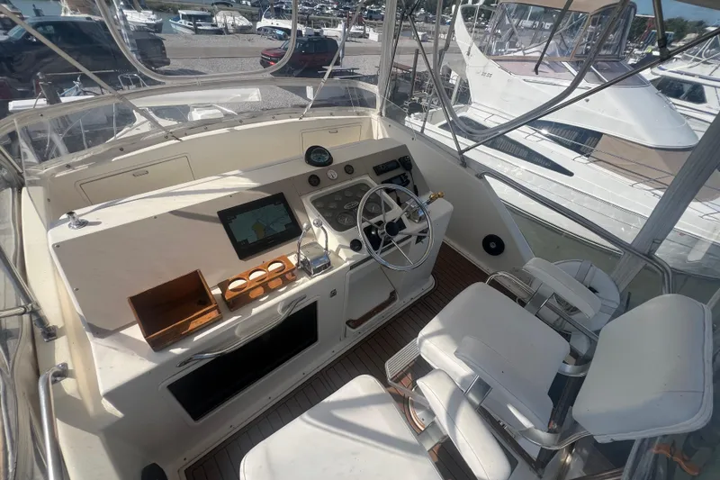 Slide: The Image of 1990 Ocean Yachts 35 Sport Sedan helm with steering wheel, navigation equipment, and seating. - 8