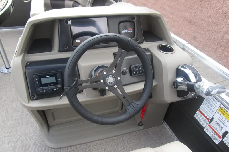 Slide: The Image of 2025 Sun Tracker PB 22 RF boat dashboard with steering wheel and control panel. - 10