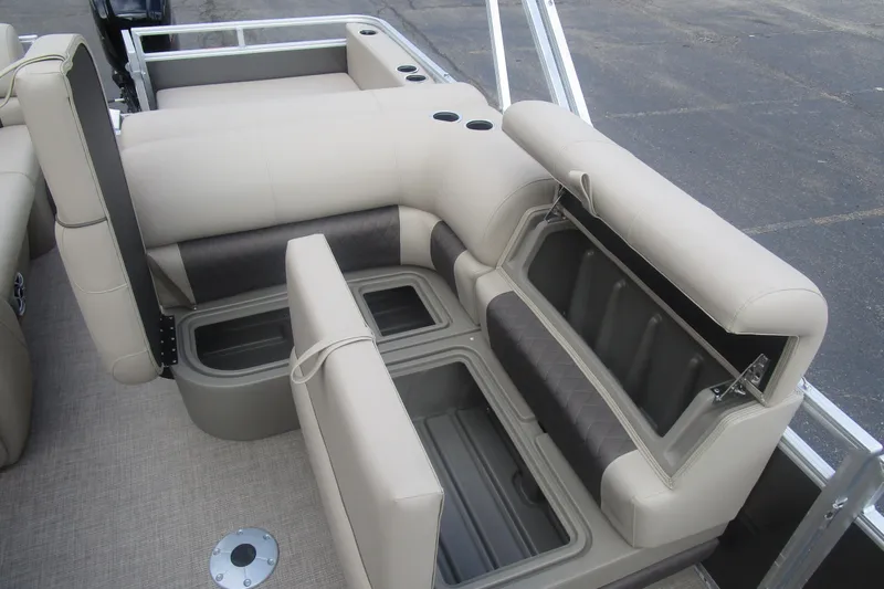 Slide: The Image of 2025 Sun Tracker PB 22 RF boat interior with beige seating and storage compartments. - 11