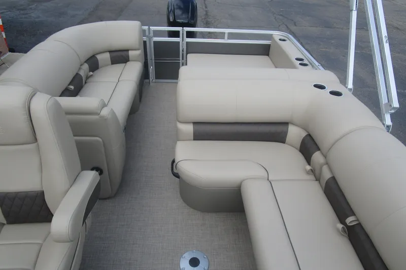Slide: The Image of 2025 Sun Tracker PB 22 RF pontoon boat interior with beige seating and cup holders. - 12