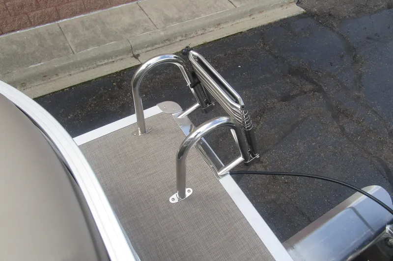 Slide: The Image of 2025 Sun Tracker PB 22 RF boat ladder on deck, featuring stainless steel construction. - 18