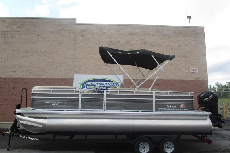Slide: The Image of 2025 Sun Tracker PB 22 RF pontoon boat with canopy at Grand Pointe Marina. - 20