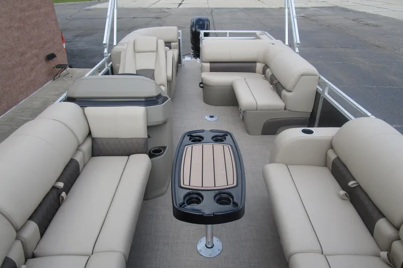 Slide: The Image of 2025 Sun Tracker PB 22 RF pontoon boat interior with beige seating and central table. - 8