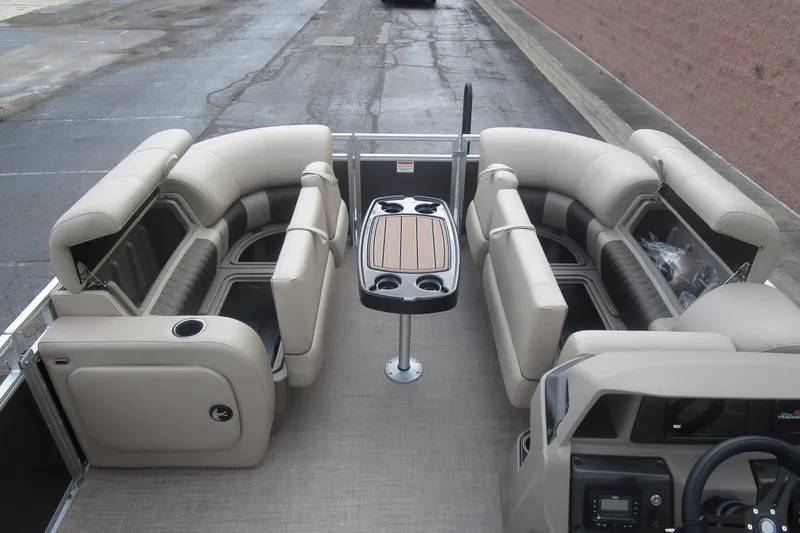 Slide: The Image of 2025 Sun Tracker PB 22 RF pontoon boat interior with beige seating and central table. - 9