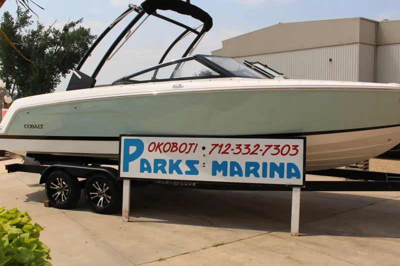 Slide: The Image of 2025 Cobalt CS23 boat at Parks Marina, Okoboji, displayed on a trailer. - 10
