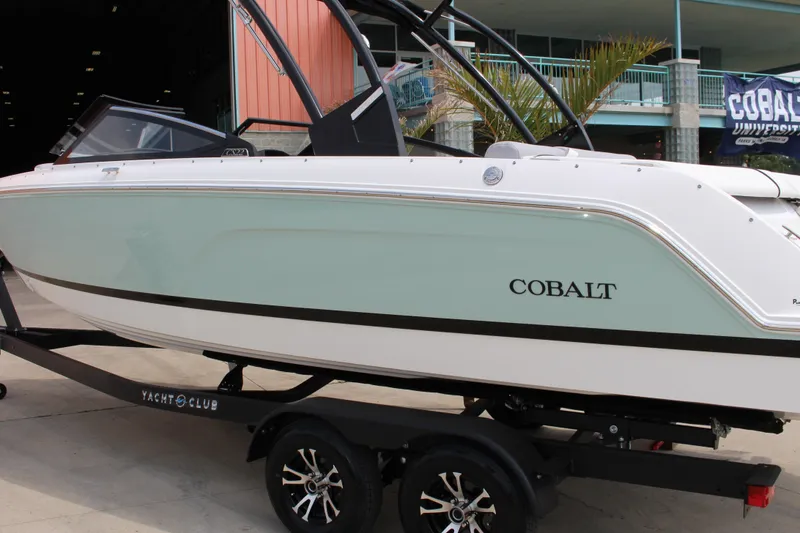 Slide: The Image of 2025 Cobalt CS23 boat on trailer, sleek design, displayed outdoors. - 17