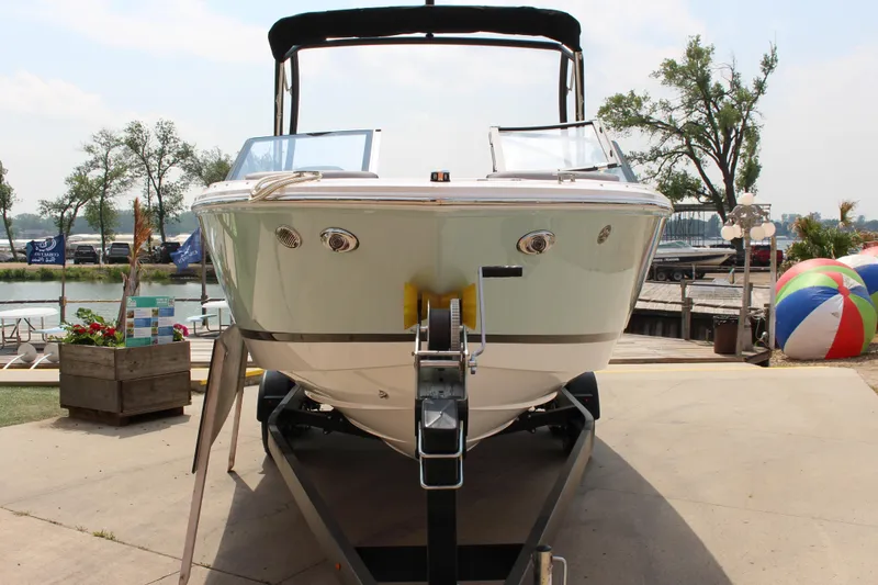 Slide: The Image of 2025 Cobalt CS23 boat on trailer at marina, sunny day. - 19