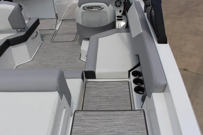Slide: The Image of 2025 Cobalt CS23 boat interior with gray seating, cup holders, and modern design. - 23
