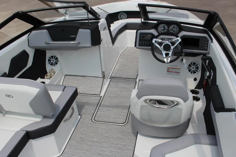 Slide: The Image of 2025 Cobalt CS23 boat interior with modern dashboard and seating. - 25