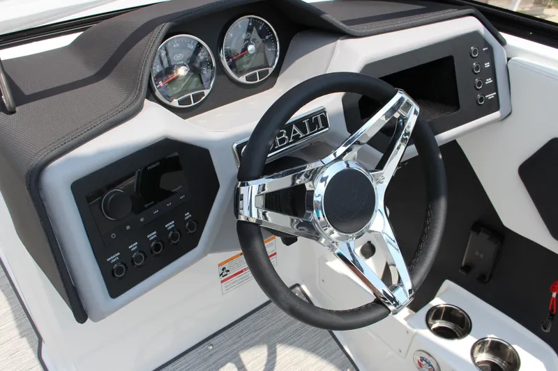Slide: The Image of 2025 Cobalt CS23 boat dashboard with chrome steering wheel and modern controls. - 3