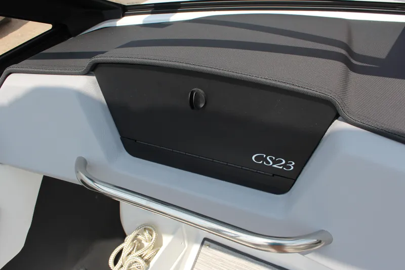 Slide: The Image of 2025 Cobalt CS23 boat interior with storage compartment and stainless steel handle. - 32