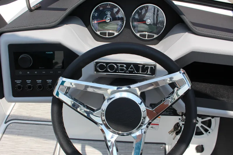 Slide: The Image of 2025 Cobalt CS23 boat dashboard with steering wheel and control panel. - 37