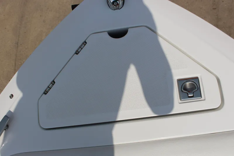 Slide: The Image of 2025 Cobalt CS23 boat deck with storage compartment and latch. - 44