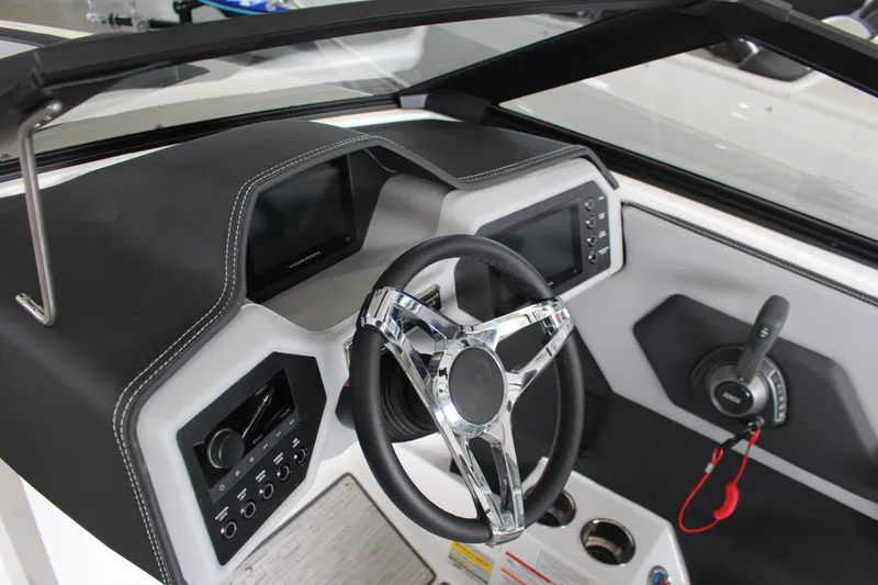 Slide: The Image of 2025 Cobalt CS23 Surf boat dashboard with modern steering wheel and controls. - 14