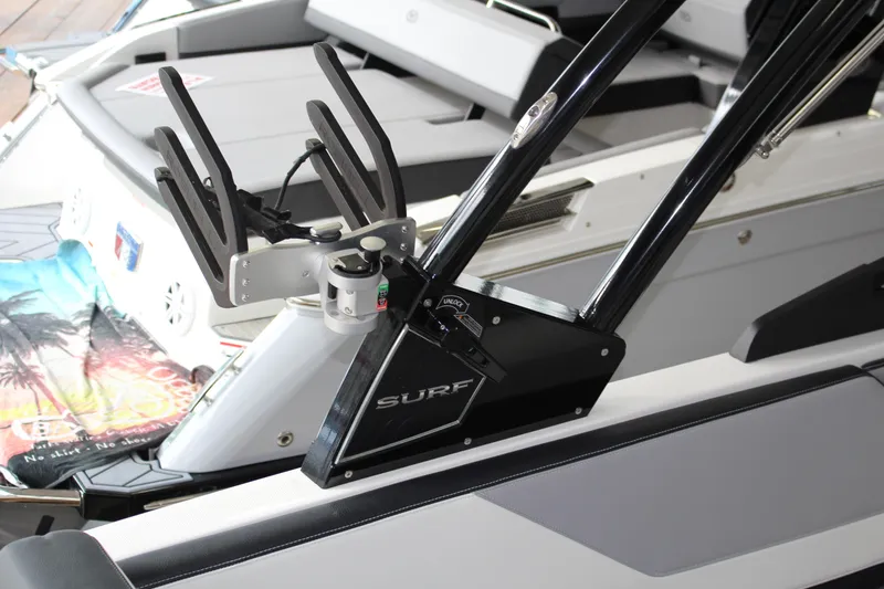 Slide: The Image of 2025 Cobalt CS23 Surf boat interior with wakeboard rack and seating. - 6