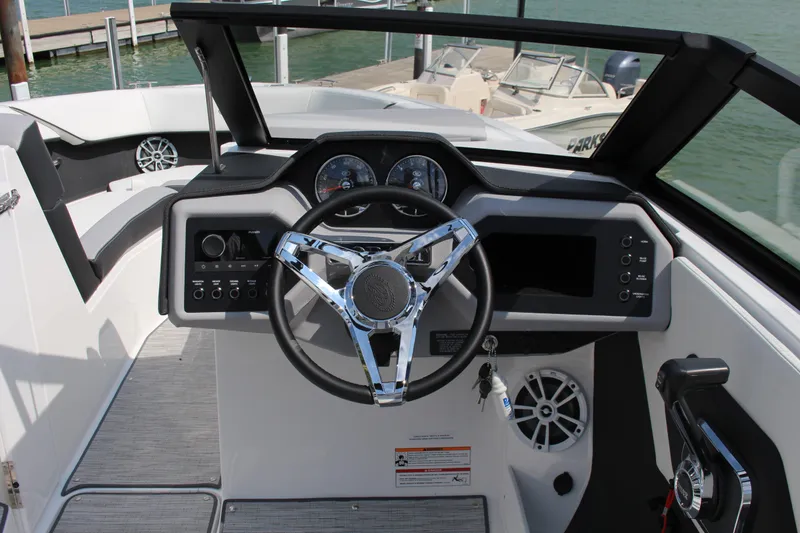 Slide: The Image of 2025 Cobalt CS23 boat dashboard with steering wheel and control panel. - 14