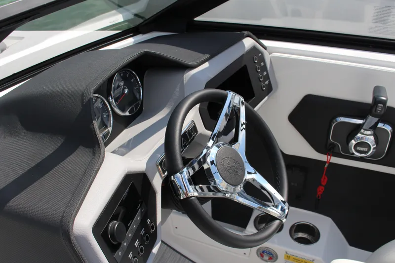 Slide: The Image of 2025 Cobalt CS23 boat dashboard with chrome steering wheel and control panel. - 16