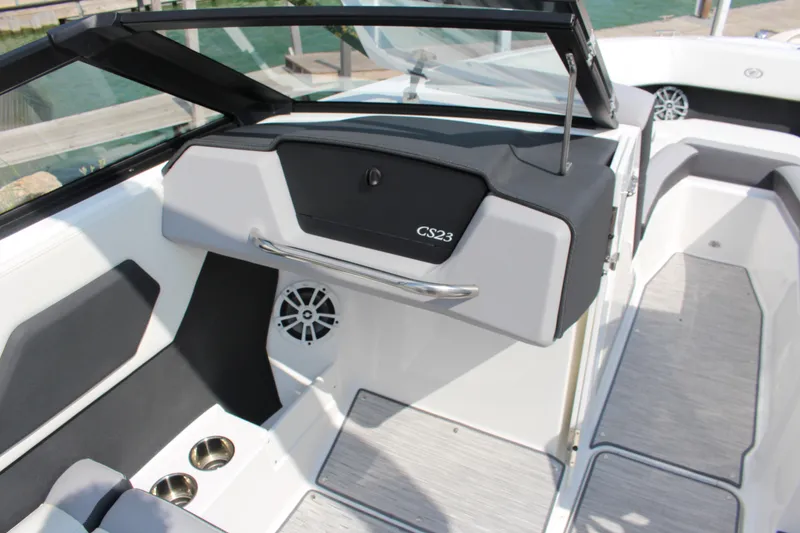 Slide: The Image of 2025 Cobalt CS23 boat interior with sleek design, cup holders, and speaker system. - 19