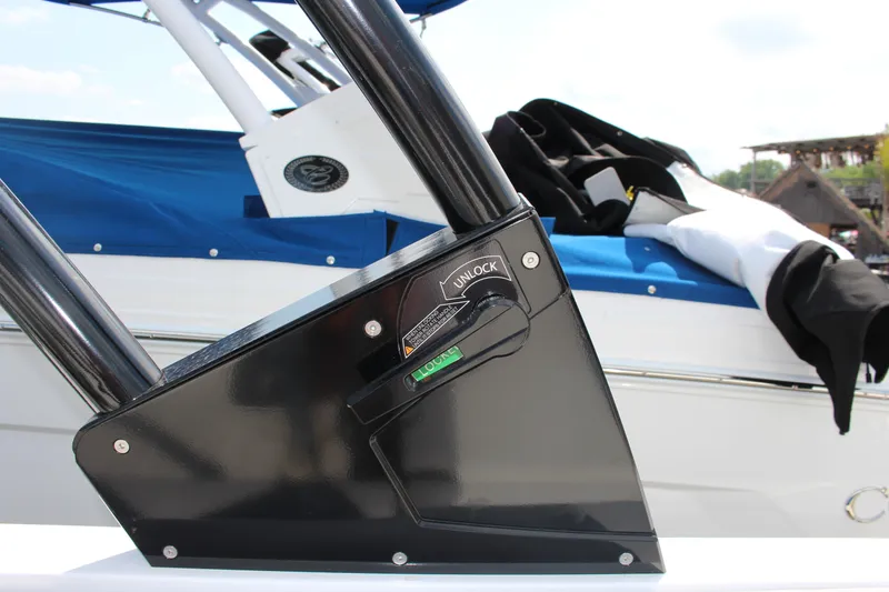 Slide: The Image of Close-up of 2025 Cobalt CS23 boat's locking mechanism with blue cover in background. - 24
