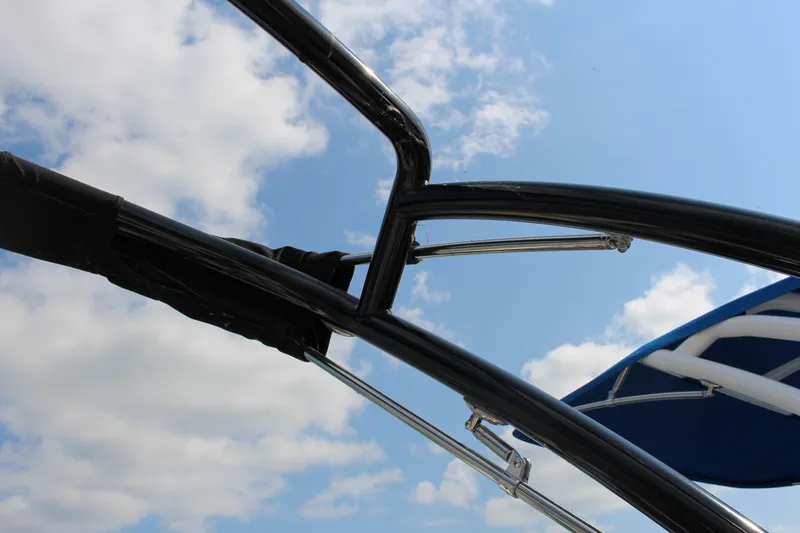 Slide: The Image of Close-up of 2025 Cobalt CS23 boat frame against a blue sky with clouds. - 25
