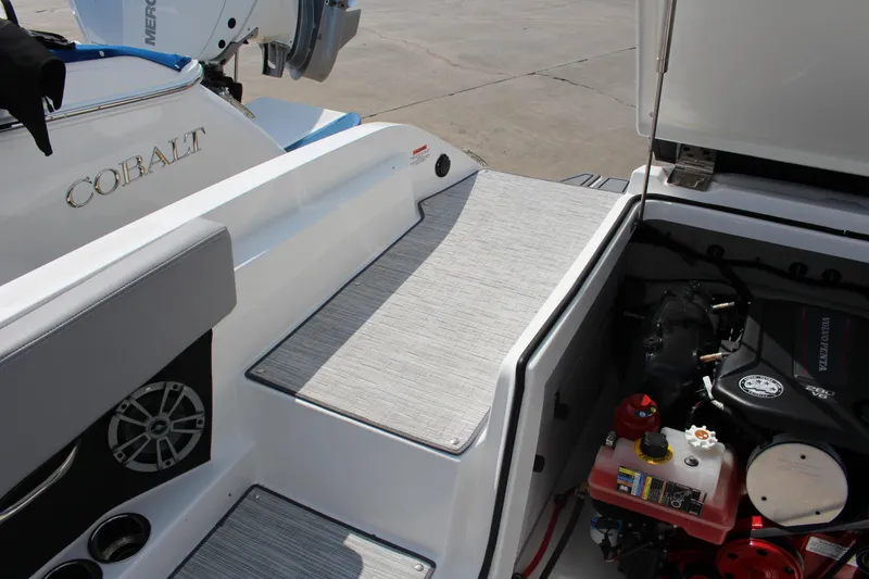 Slide: The Image of 2025 Cobalt CS23 boat engine compartment with Volvo Penta engine and sleek interior design. - 30