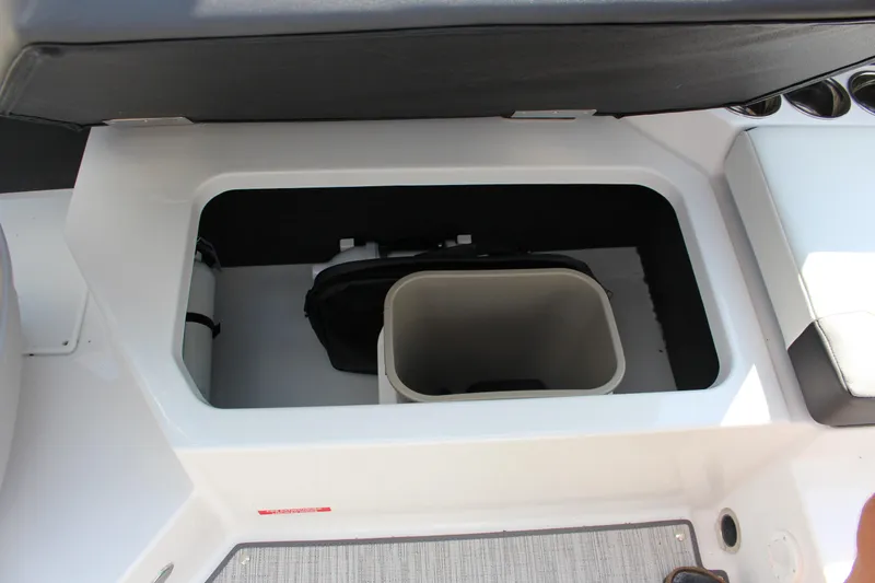 Slide: The Image of 2025 Cobalt CS23 boat storage compartment with integrated cooler and seating. - 31