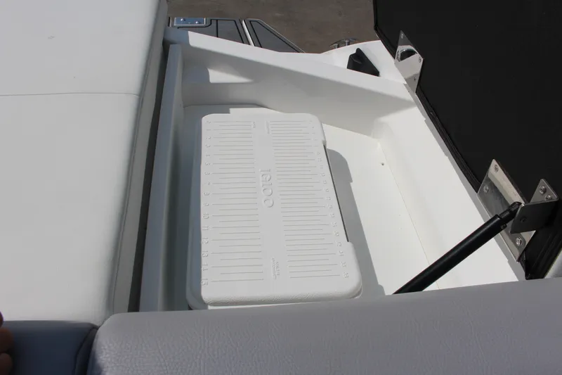 Slide: The Image of 2025 Cobalt CS23 boat storage compartment with integrated cooler. - 32