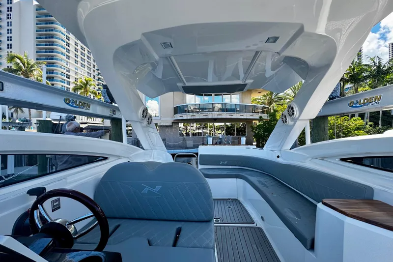 Slide: The Image of 2024 NX Boats NX 280 interior with modern design, docked near luxury buildings. - 14