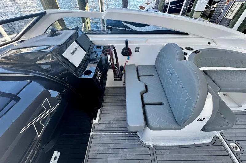 Slide: The Image of 2024 NX Boats NX 280 cockpit with modern controls and comfortable seating. - 15