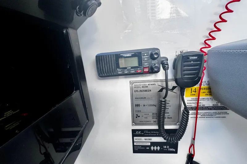 Slide: The Image of Control panel of 2024 NX Boats NX 280 with Uniden radio equipment. - 19