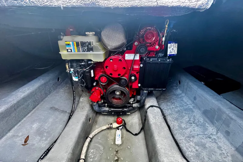Slide: The Image of Engine compartment of 2024 NX Boats NX 280, showcasing a red marine engine. - 23