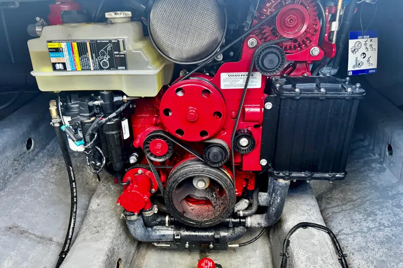 Slide: The Image of Engine compartment of 2024 NX Boats NX 280, featuring a red Volvo Penta engine. - 24