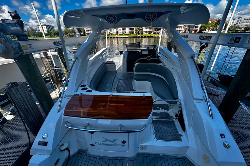 Slide: The Image of 2024 NX Boats NX 280 docked, showcasing sleek design and luxurious interior. - 7