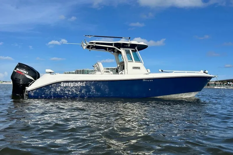 Slide: The Image of 2008 Everglades 290 CC boat on water, blue hull, Suzuki outboard motor. - 12