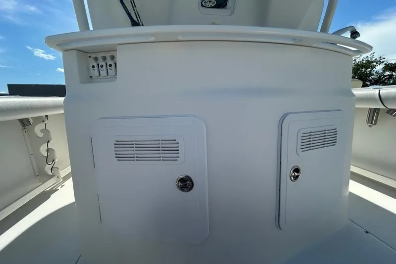 Slide: The Image of 2008 Everglades 290 CC boat console with storage compartments and control panel. - 13