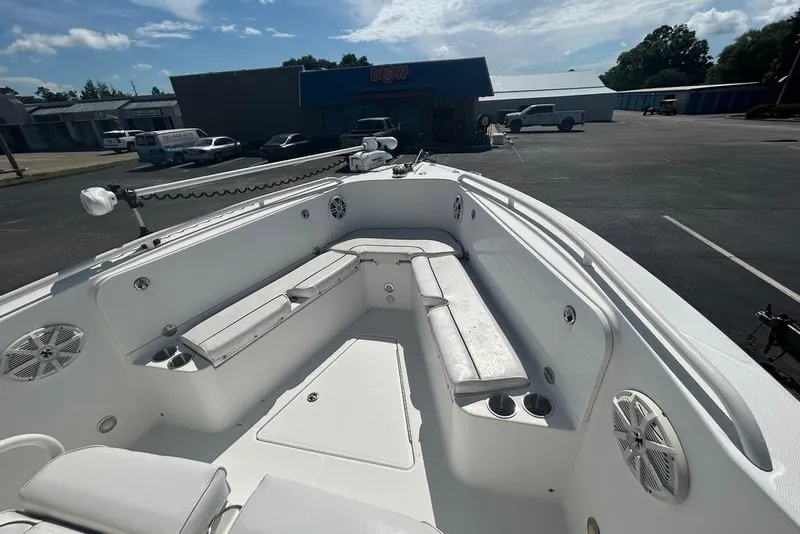 Slide: The Image of 2008 Everglades 290 CC boat interior with seating and speakers in a parking lot. - 14