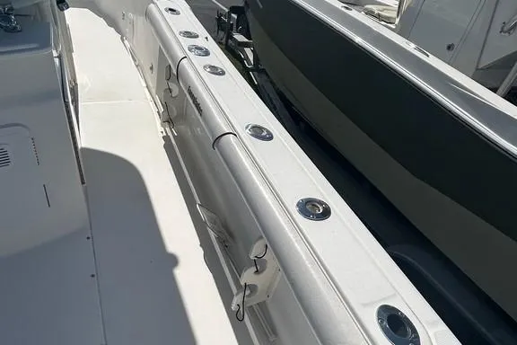 Slide: The Image of 2008 Everglades 290 CC boat deck with rod holders and storage compartments. - 15