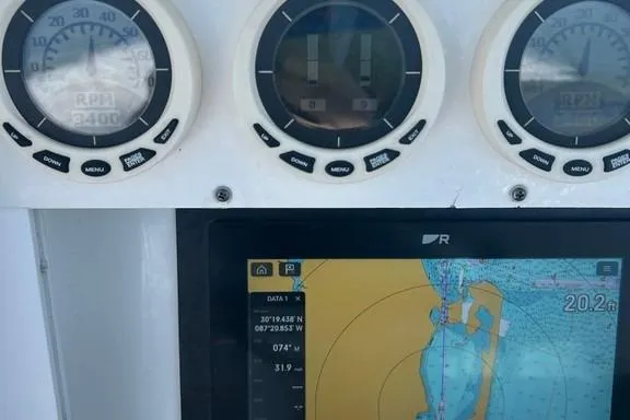 Slide: The Image of Dashboard of 2008 Everglades 290 CC boat with navigation and RPM gauges. - 16