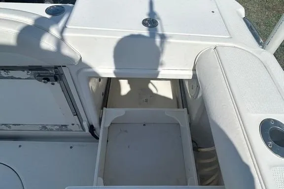 Slide: The Image of 2008 Everglades 290 CC boat interior with open storage compartment and cup holders. - 17