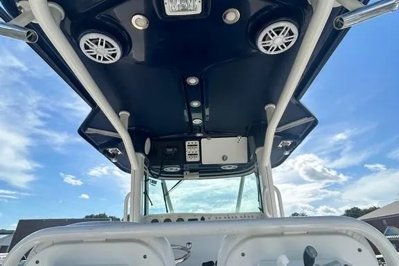 Slide: The Image of 2008 Everglades 290 CC boat console with speakers and controls under a clear sky. - 18
