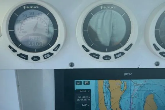 Slide: The Image of Dashboard of 2008 Everglades 290 CC boat with Suzuki gauges and navigation display. - 19